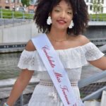 Candidate n°13, Vanhy, 25 ans, aspirante Miss Tournai 2025, souriante en tenue élégante.